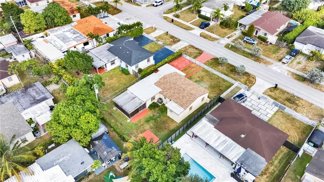an aerial view of a house with a yard
