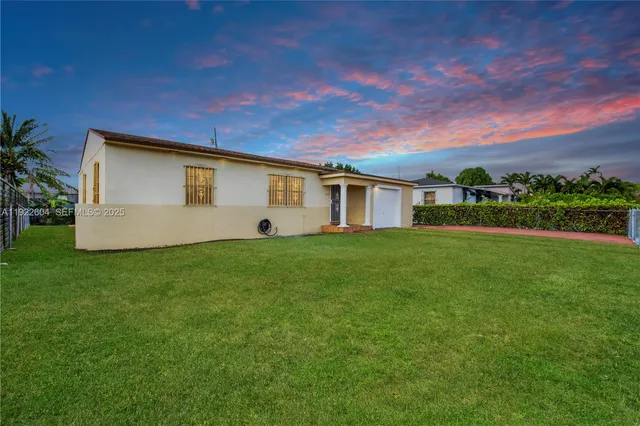 a view of a house with a backyard