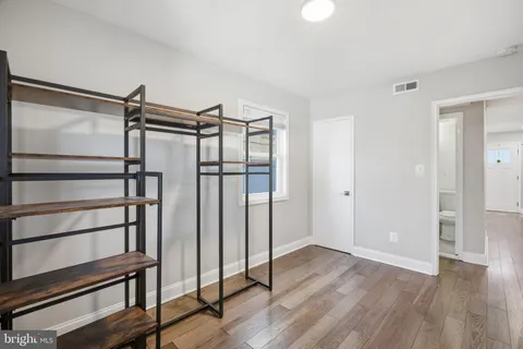 a view of a room with wooden floor and window