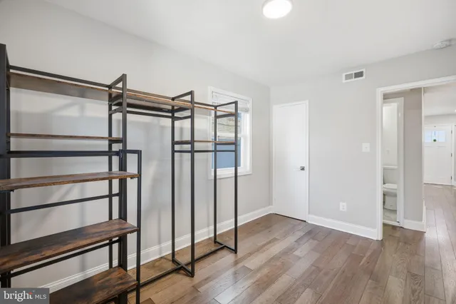 a view of a room with wooden floor and window