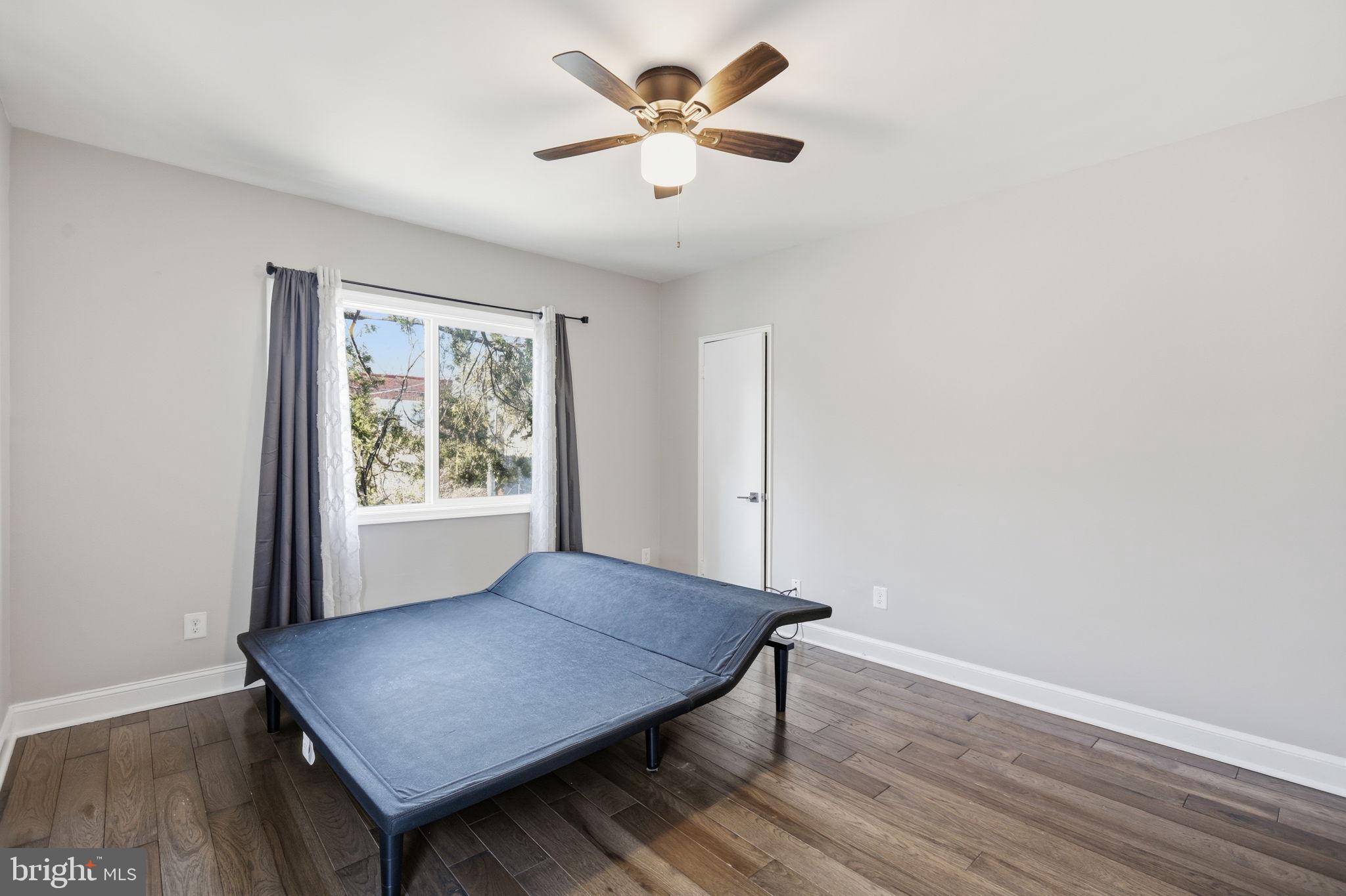 422 Burbank Street Southeast Washington, DC 20019 - Photo 15 of 23 a view of a room with a window and wooden floor