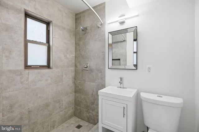 a bathroom with a toilet sink and shower