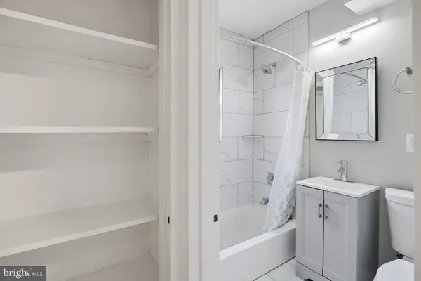 a bathroom with a bathtub a sink a toilet and a shower