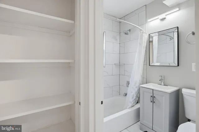 a bathroom with a bathtub a sink a toilet and a shower