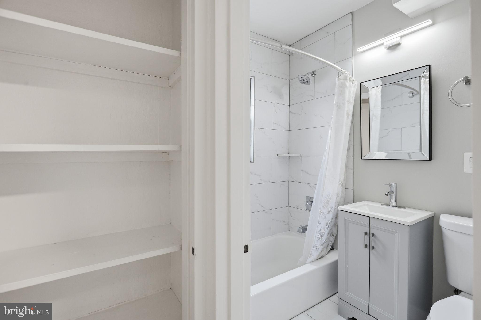 422 Burbank Street Southeast Washington, DC 20019 - Photo 17 of 23 a bathroom with a bathtub a sink a toilet and a shower