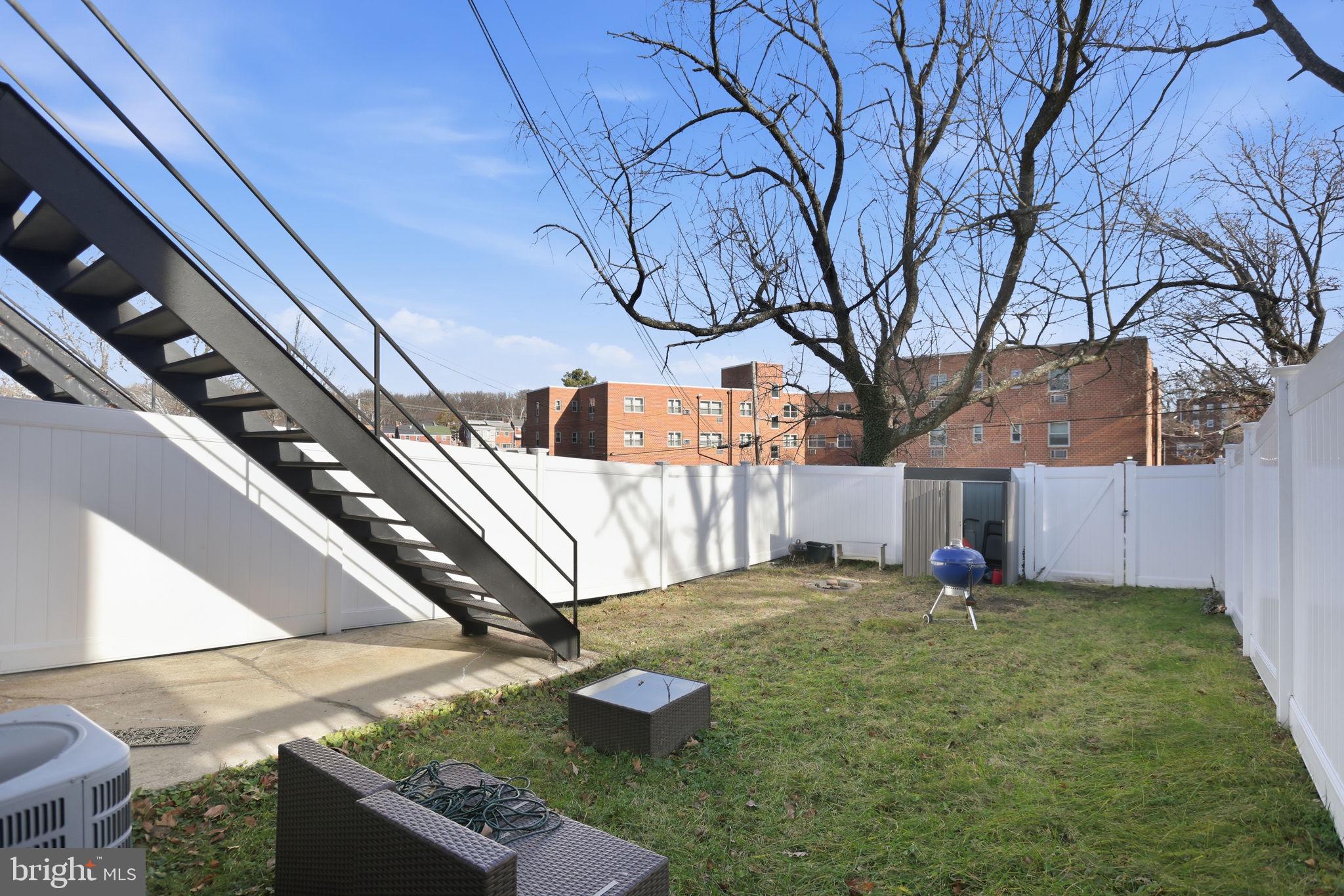 422 Burbank Street Southeast Washington, DC 20019 - Photo 20 of 23 a view of a backyard with brick wall and potted plants