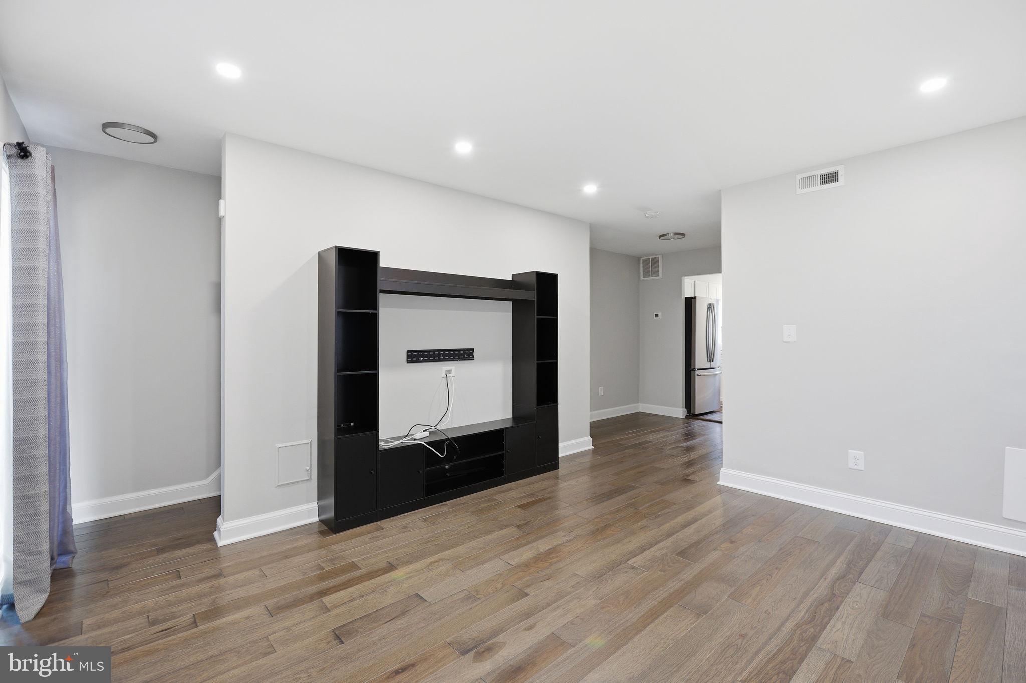 422 Burbank Street Southeast Washington, DC 20019 - Photo 6 of 23 a view of a hallway with wooden floor and staircase