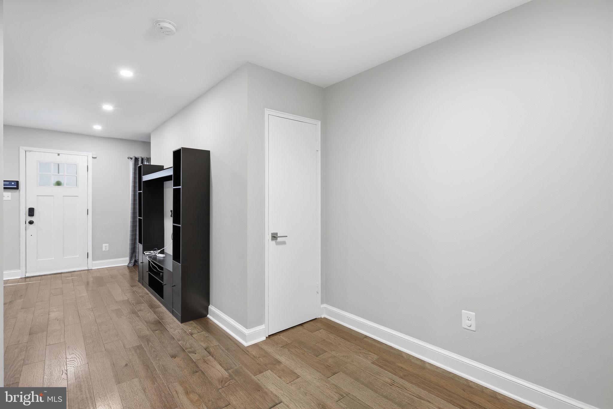 422 Burbank Street Southeast Washington, DC 20019 - Photo 8 of 23 a view of an empty room with wooden floor and a window
