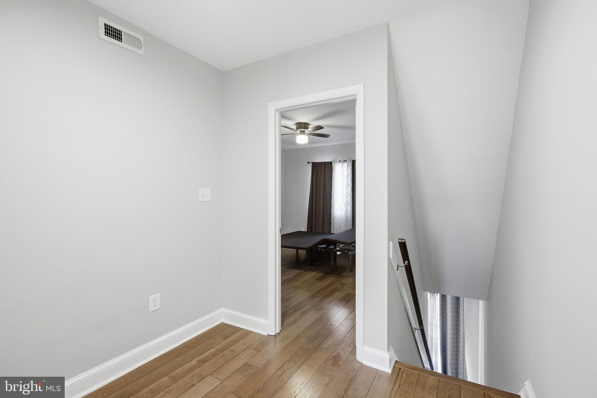 422 Burbank Street Southeast Washington, DC 20019 - Photo 9 of 23 a view of a hallway with wooden floor and staircase