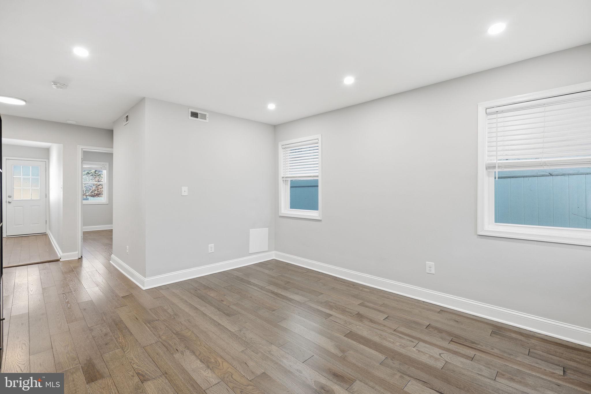 422 Burbank Street Southeast Washington, DC 20019 - Photo 10 of 23 a view of an empty room with wooden floor and a window