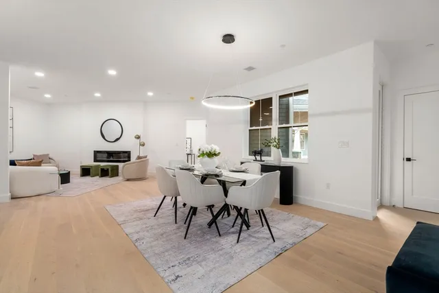 a living room with furniture a rug and a large window