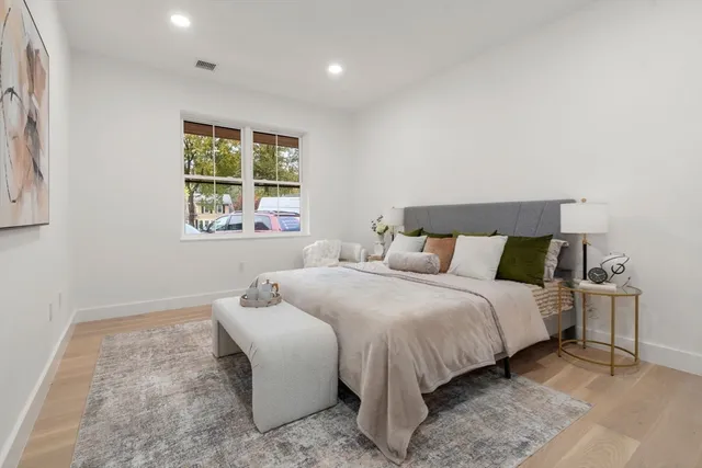 a bedroom with bed and window
