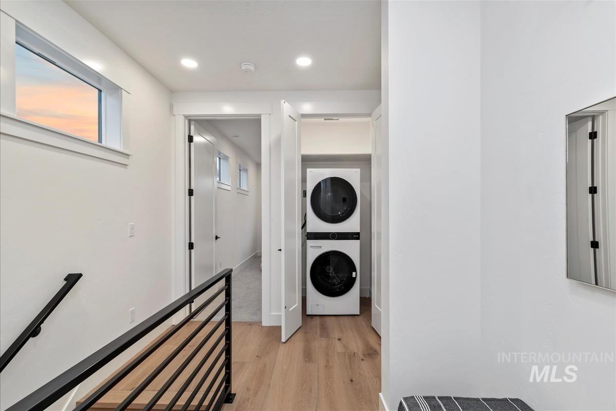 3219 West Moore Street Boise, ID 83702 - Photo 22 of 34 Laundry room featuring light wood-type flooring, stacked washer / dryer, and recessed lighting
