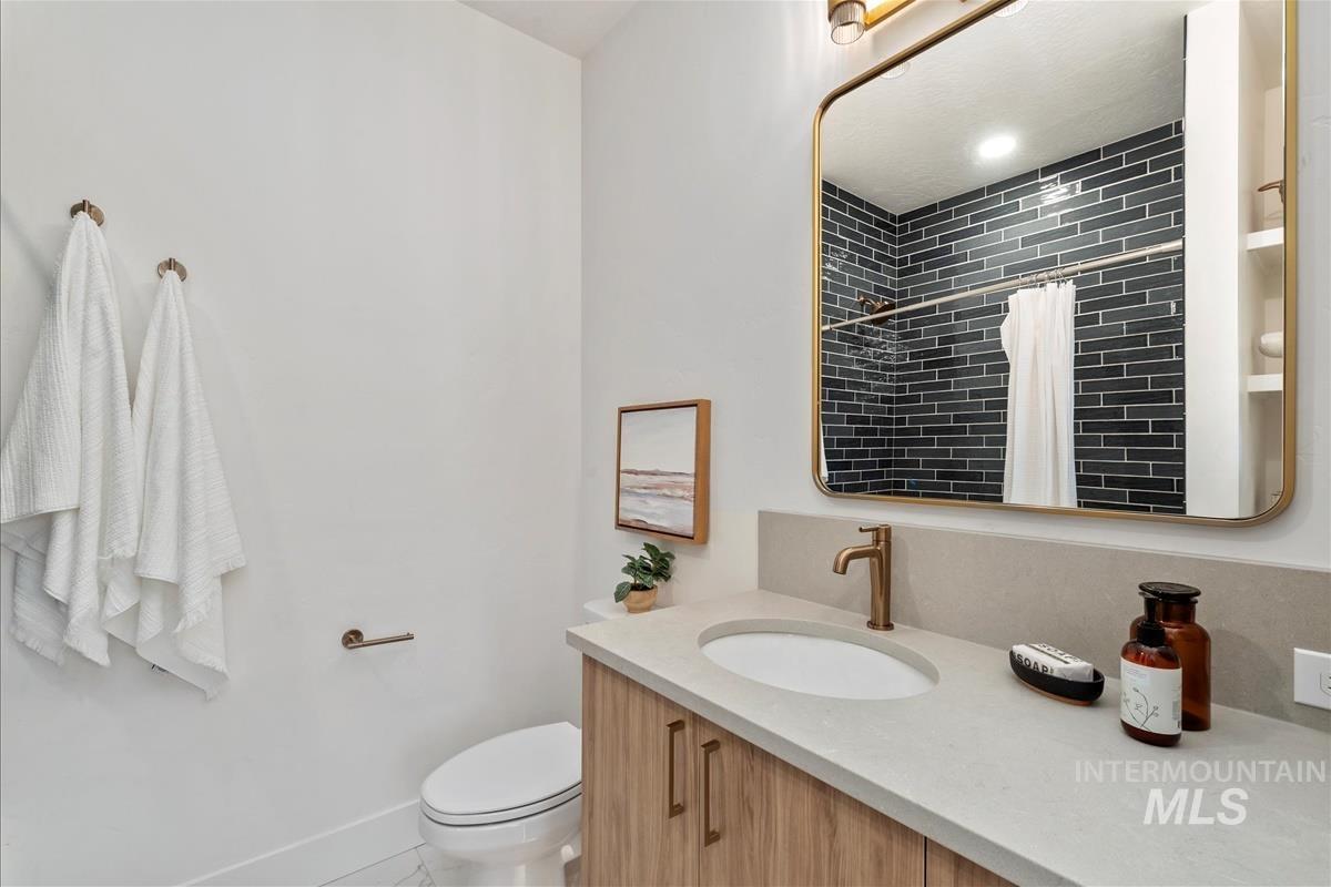 3219 West Moore Street Boise, ID 83702 - Photo 27 of 34 Bathroom with curtained shower, vanity, and light tile patterned floors