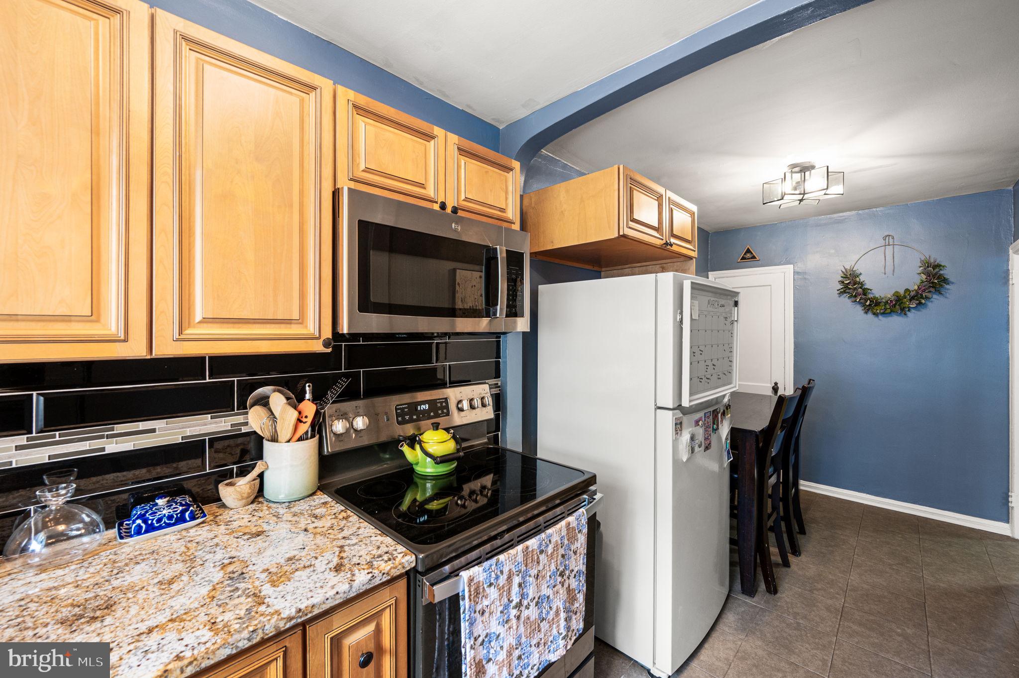 828 Derwyn Road Drexel Hill, PA 19026 - Photo 7 of 25 a kitchen with stainless steel appliances granite countertop a refrigerator and a stove top oven