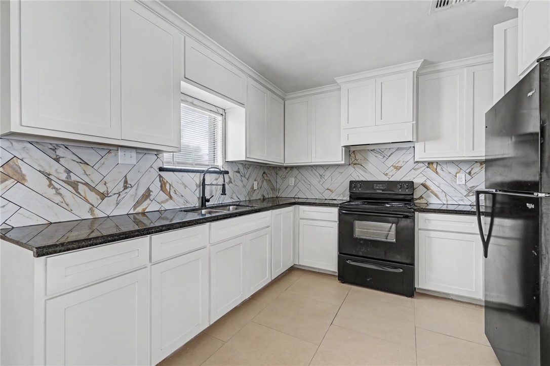 302 Palm Tree Drive Mathis, TX 78368 - Photo 11 of 28 a kitchen with stainless steel appliances granite countertop a sink and a stove