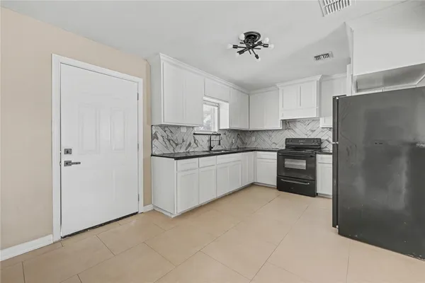 a kitchen with stainless steel appliances a refrigerator sink and cabinets