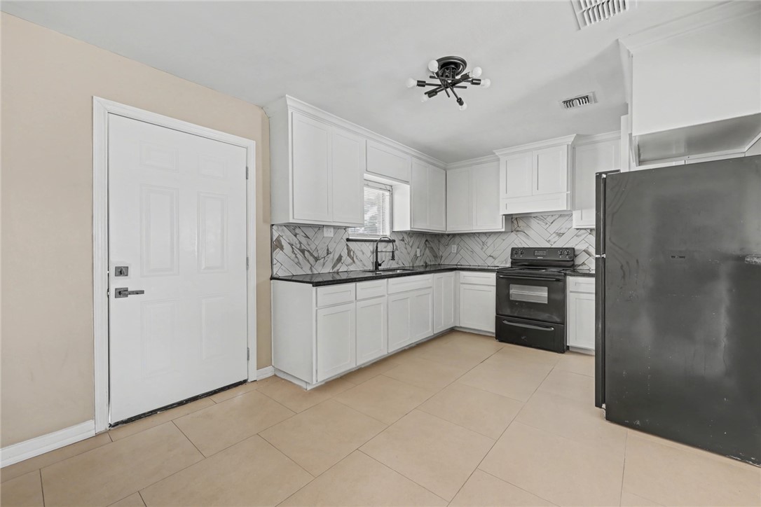 302 Palm Tree Drive Mathis, TX 78368 - Photo 12 of 28 a kitchen with stainless steel appliances a refrigerator sink and cabinets