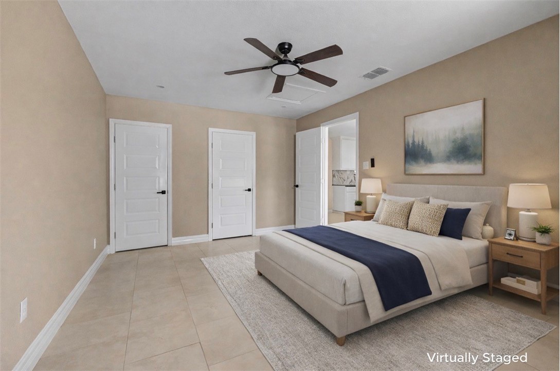 302 Palm Tree Drive Mathis, TX 78368 - Photo 13 of 28 a spacious bedroom with a bed and a ceiling fan