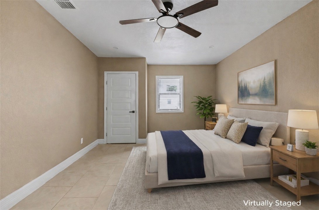 302 Palm Tree Drive Mathis, TX 78368 - Photo 15 of 28 a bedroom with a large bed and a chandelier