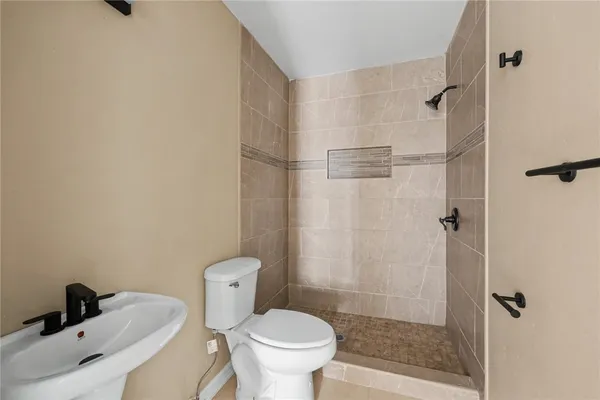 a bathroom with a toilet and a shower