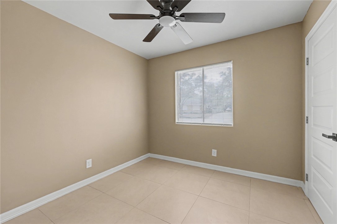 302 Palm Tree Drive Mathis, TX 78368 - Photo 21 of 28 an empty room with a window and a fan