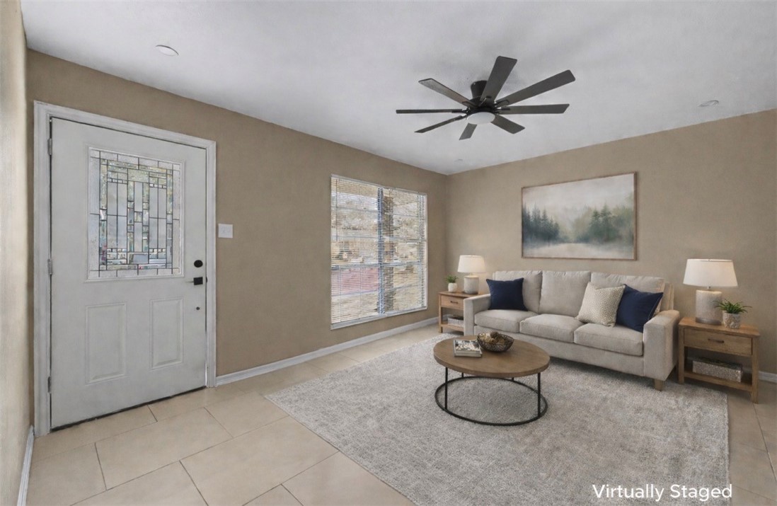 302 Palm Tree Drive Mathis, TX 78368 - Photo 3 of 28 a living room with furniture a window and a ceiling fan