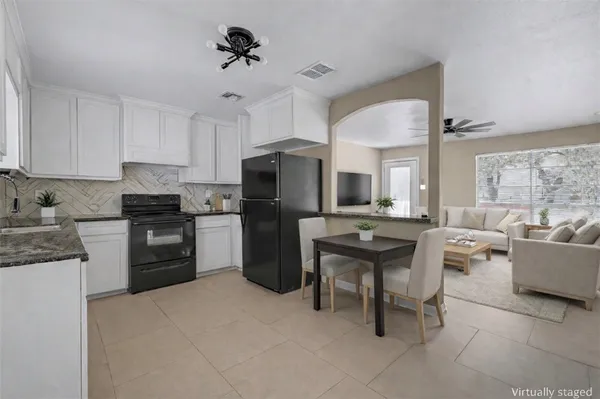 a kitchen with a refrigerator and a stove top oven
