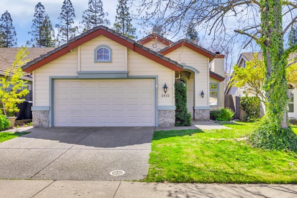 a front view of a house with a yard and garage