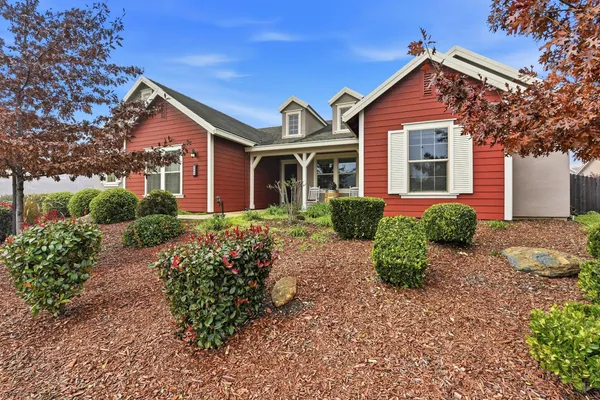 a front view of a house with garden