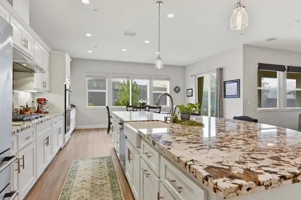a kitchen with sink stove and cabinets