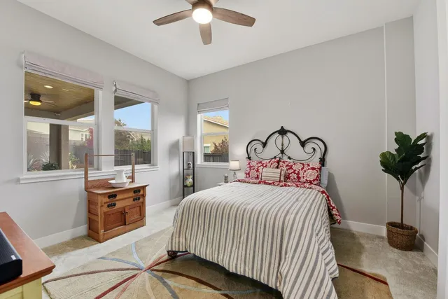 a bedroom with a bed and a large window with garden view