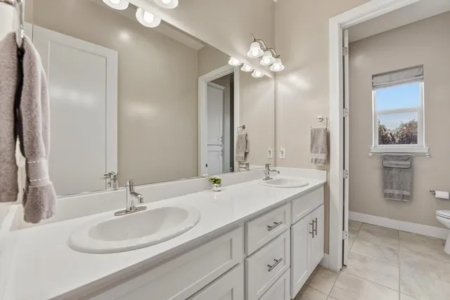 a bathroom with a double vanity sink and a mirror