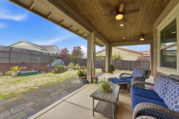 a building outdoor space with patio furniture and potted plants