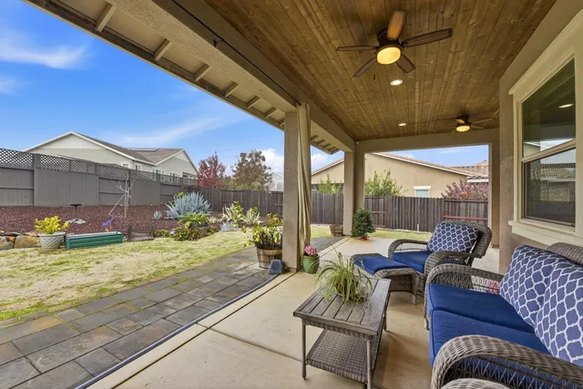 a building outdoor space with patio furniture and potted plants