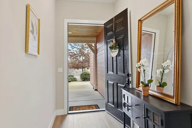 a view of a porch with wooden floor and windows