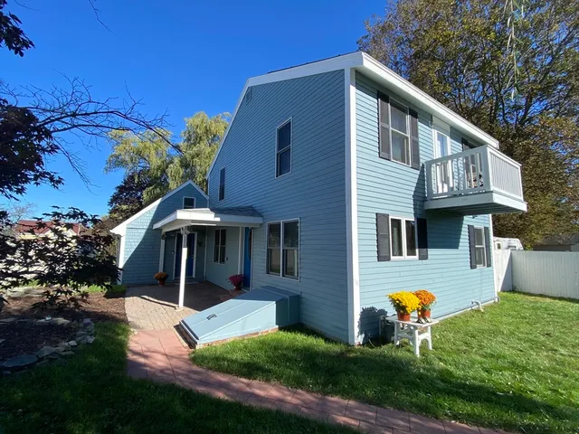 a view of house with backyard tub and fire pit