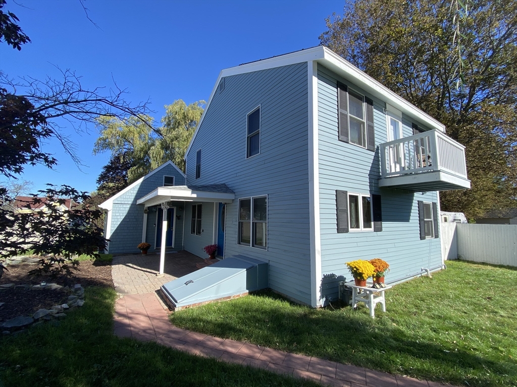a view of house with backyard tub and fire pit