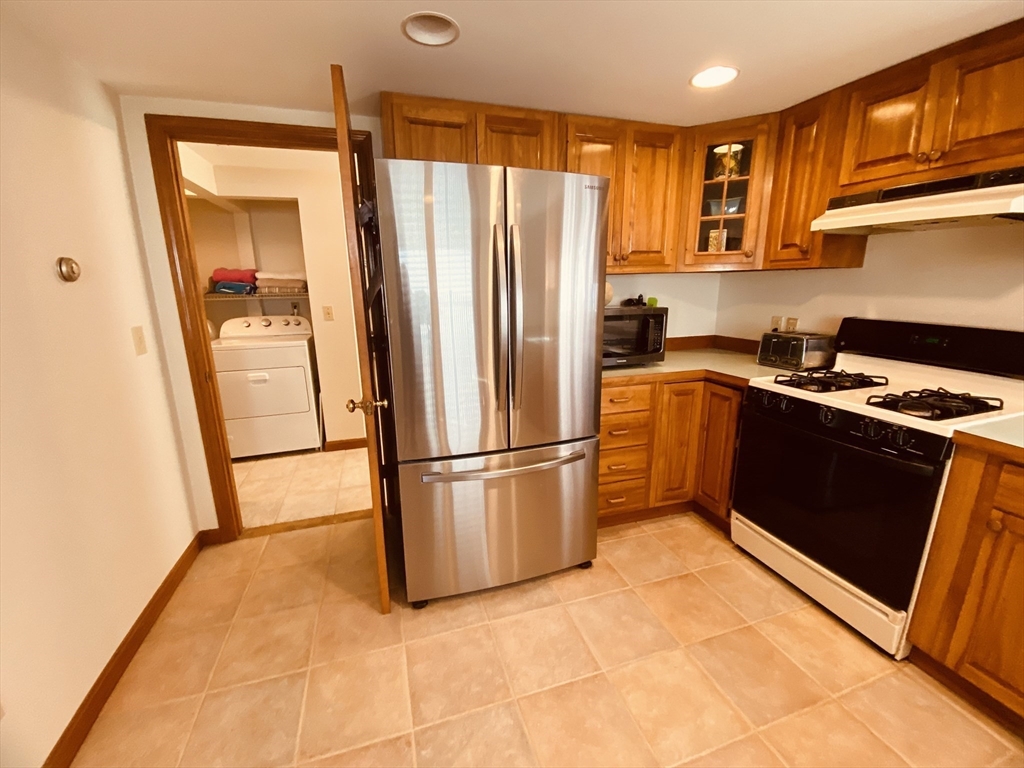 1 Warren Avenue Salisbury, MA 01952 - Photo 12 of 29 a kitchen with stainless steel appliances granite countertop a refrigerator sink and cabinets