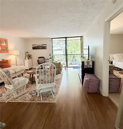 a living room with furniture large window and a table