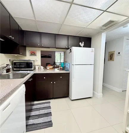 a kitchen with stainless steel appliances a refrigerator stove microwave and sink
