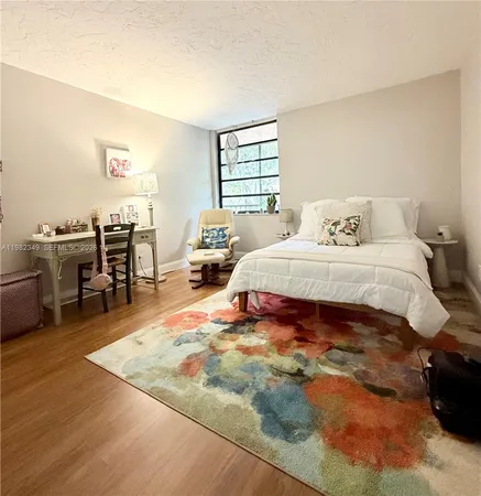 a bedroom with a bed a table and chair