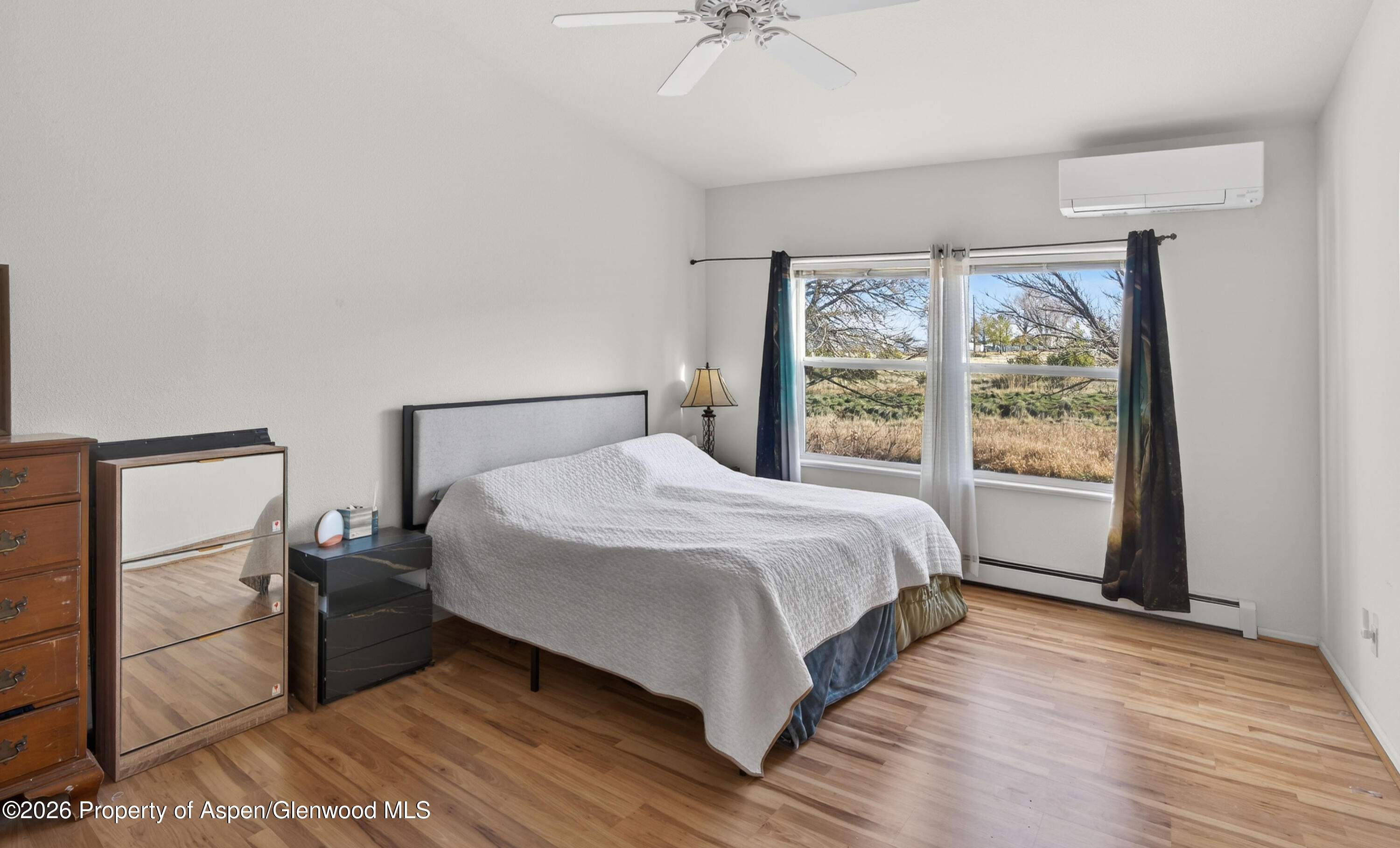 51 North Ridge Court Parachute, CO 81635 - Photo 12 of 28 a large bed sitting in a bedroom next to a window