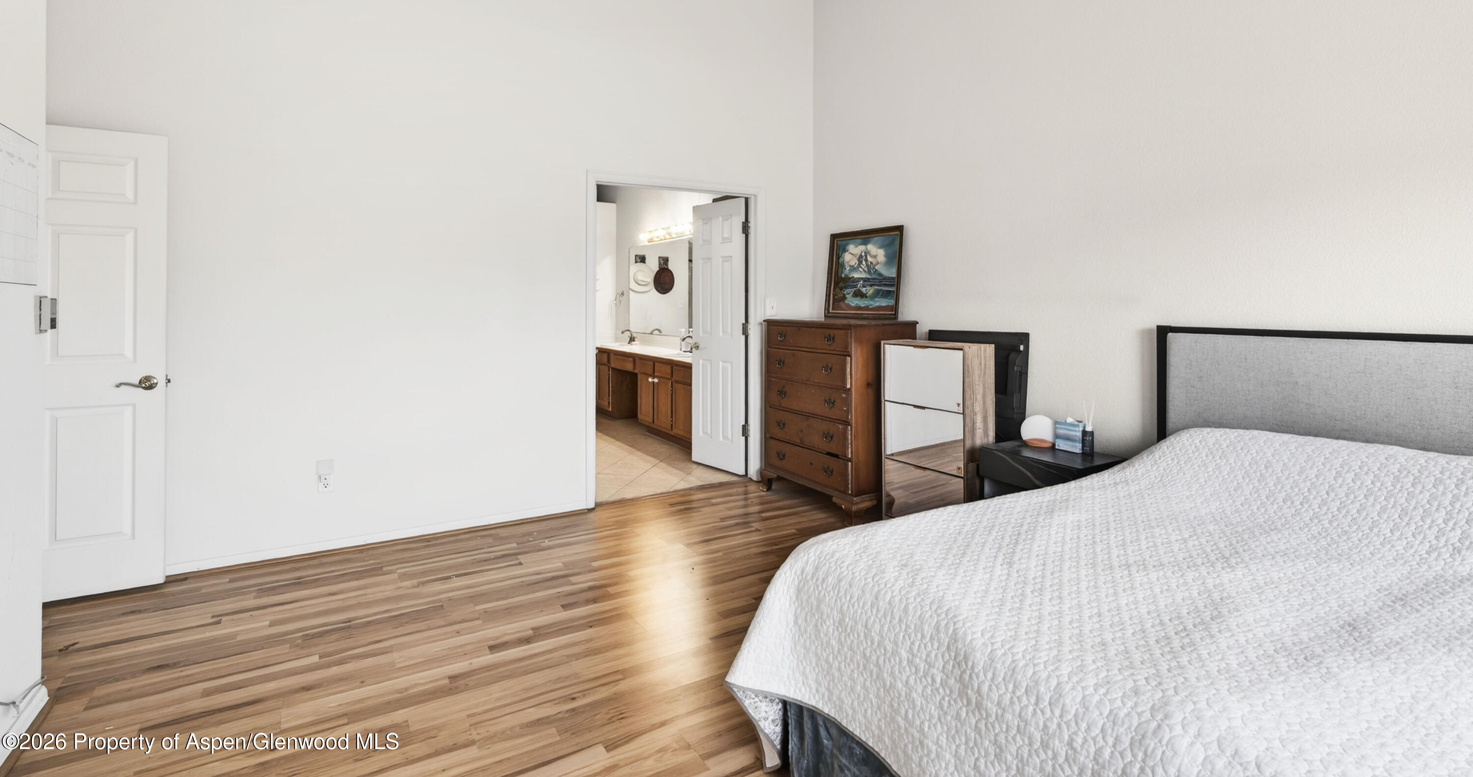51 North Ridge Court Parachute, CO 81635 - Photo 13 of 28 a bedroom with a bed and wooden floor