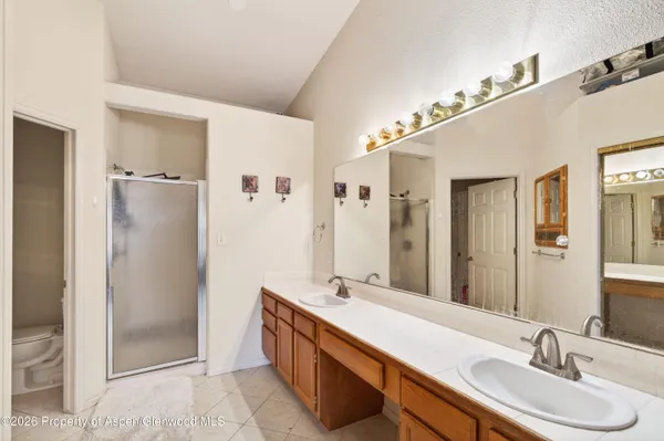 a bathroom with a granite countertop shower mirror and a sink