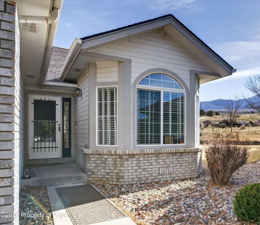 a front view of a house with a large window