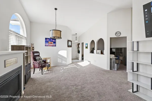 a living room with furniture a window and kitchen view