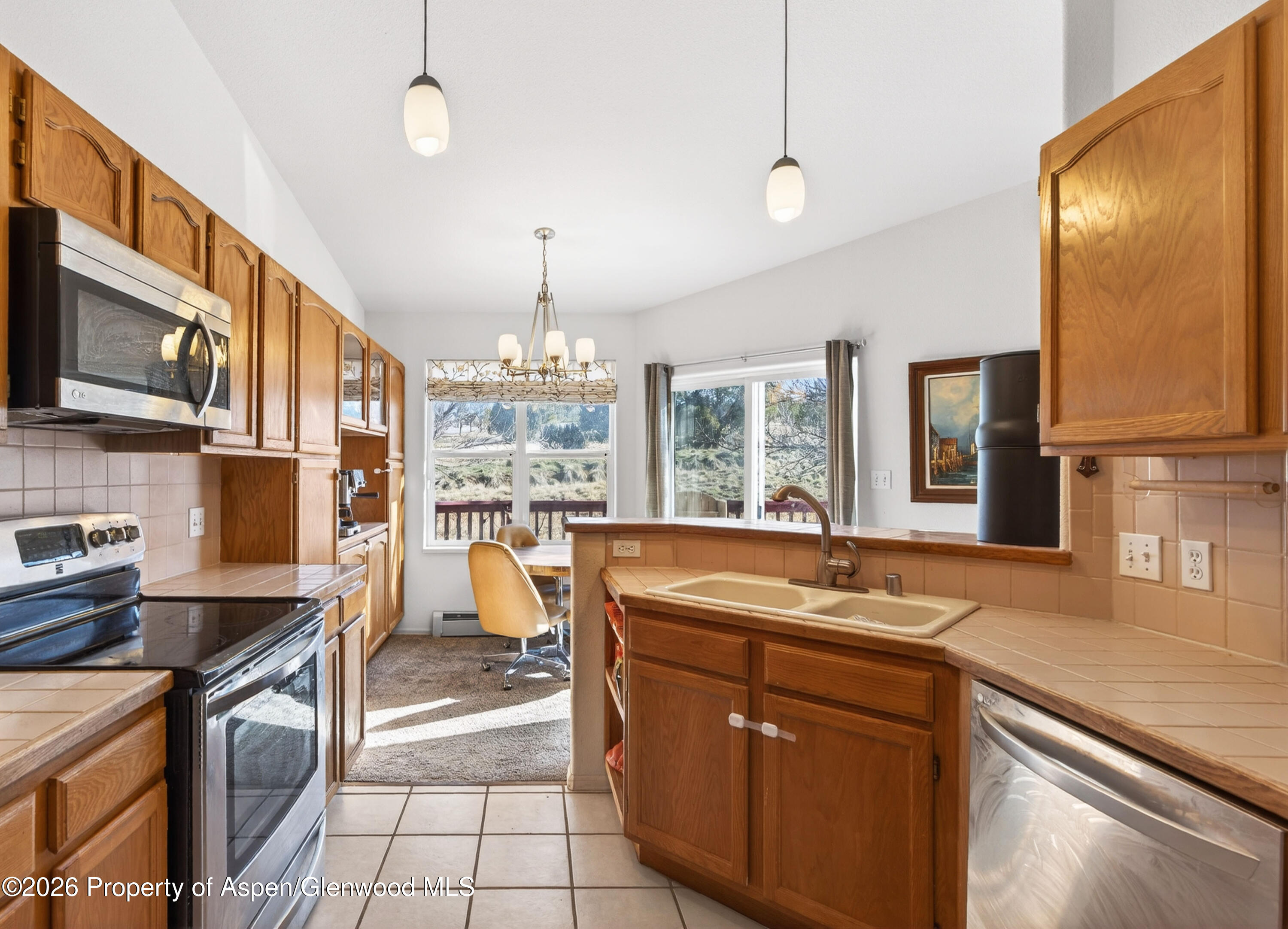 51 North Ridge Court Parachute, CO 81635 - Photo 7 of 28 a kitchen with stainless steel appliances granite countertop a sink stove and cabinets
