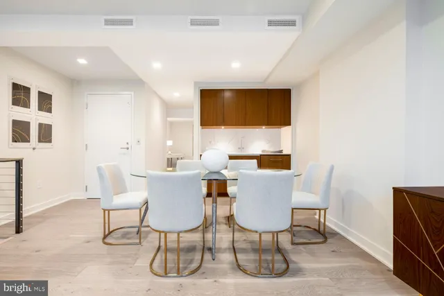 a living room with furniture and large windows