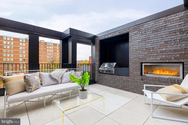 a living room with patio furniture and a flat screen tv